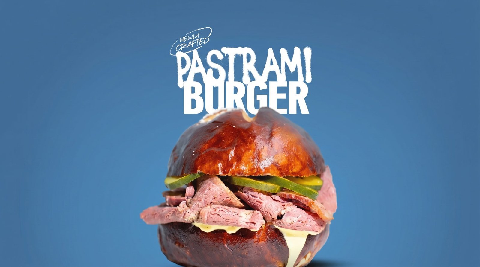 Newly crafted Pastrami Burger — house-smoked brisket on a pretzel bun